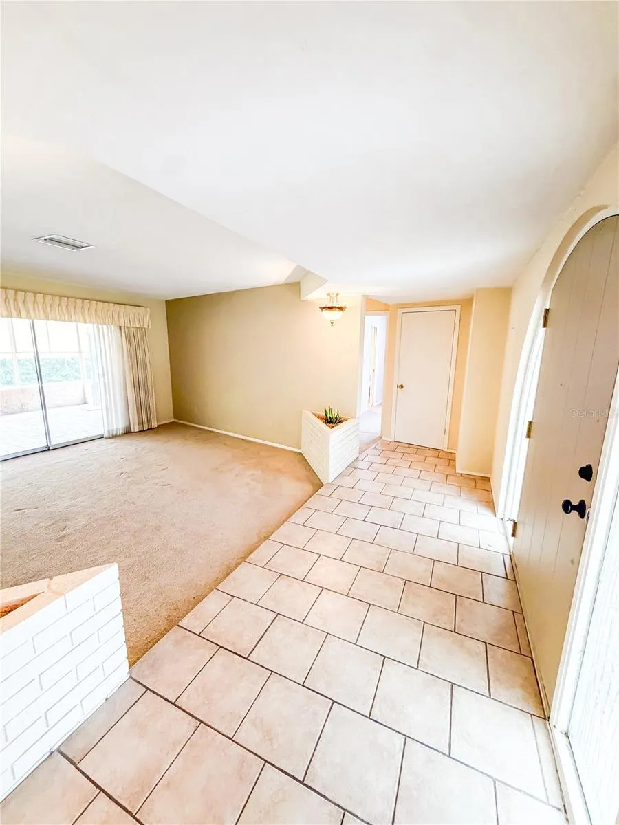 The kitchen dining room family room primary suite laundry room and garage are to the left of the entry and Bedrooms 2 and 3 are to the right.