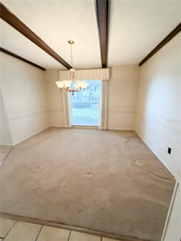 Dining room is off the front entry and the kitchen.  The architectural beams add a fabulous look in this room.