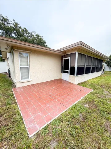 The backyard has an open patio for your grill and a spot to get some Florida sunshine.