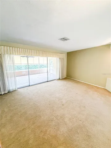 The spacious living room features sliders to the large screened in lanai.