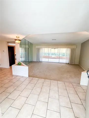 The entry is tiled and goes off to the right and left of the front door.  The large living room is straight ahead.