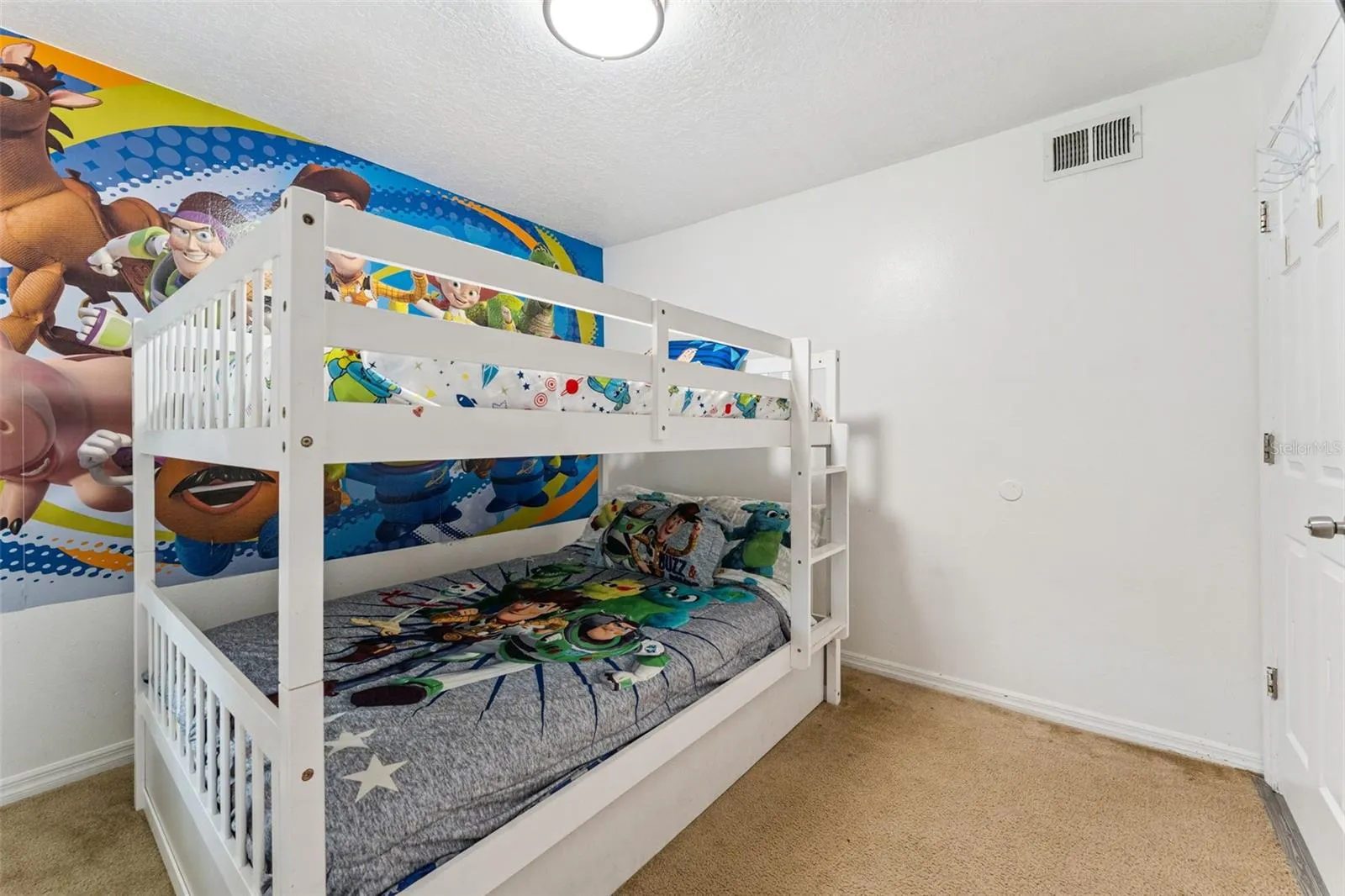 Bunk Bed Room: Fun character-themed guest room equipped with sturdy white wooden bunk beds and plush carpeting.