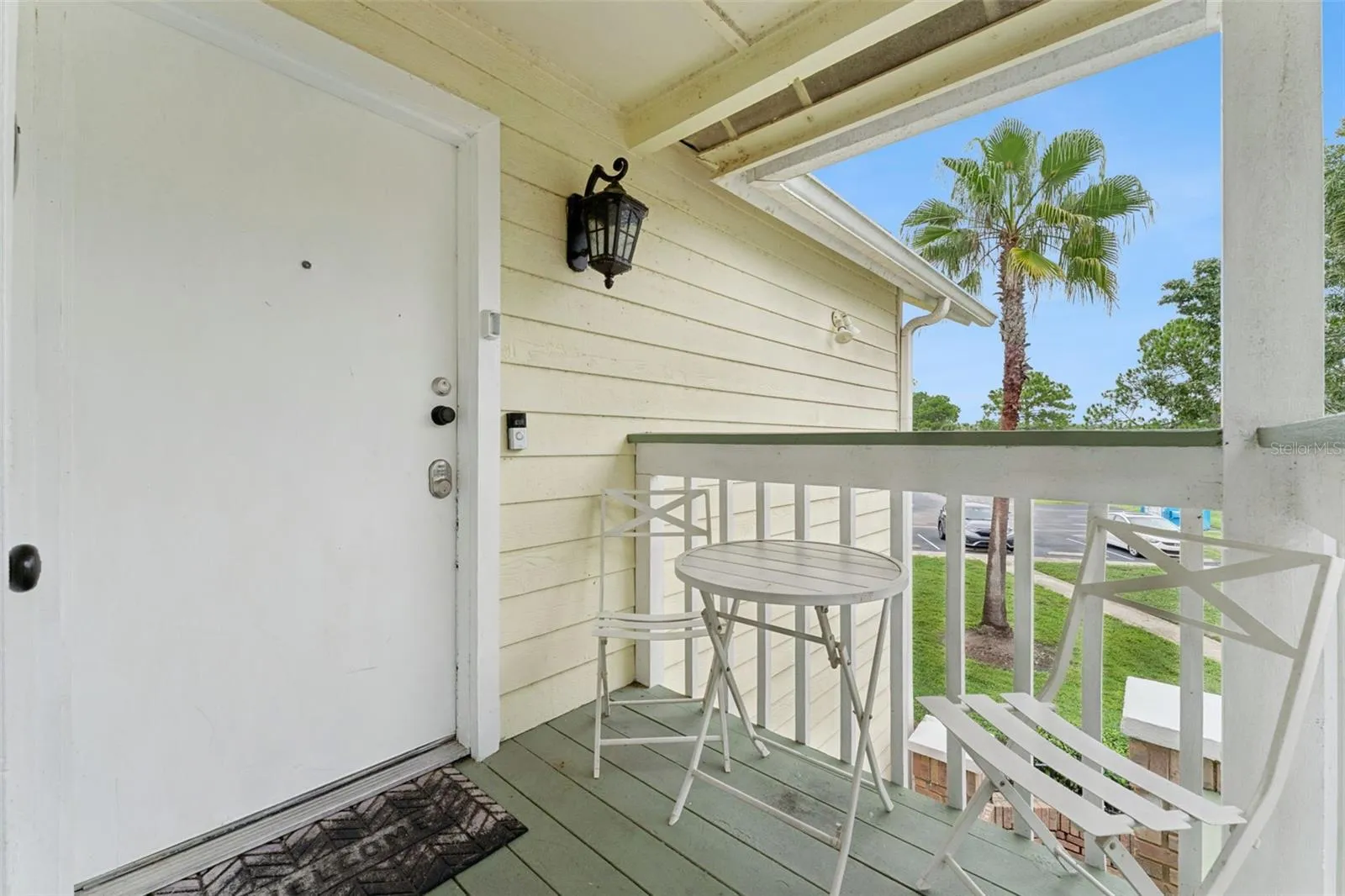 Private Porch Entry: Secluded covered entry balcony with room for small patio seating and views of the community grounds