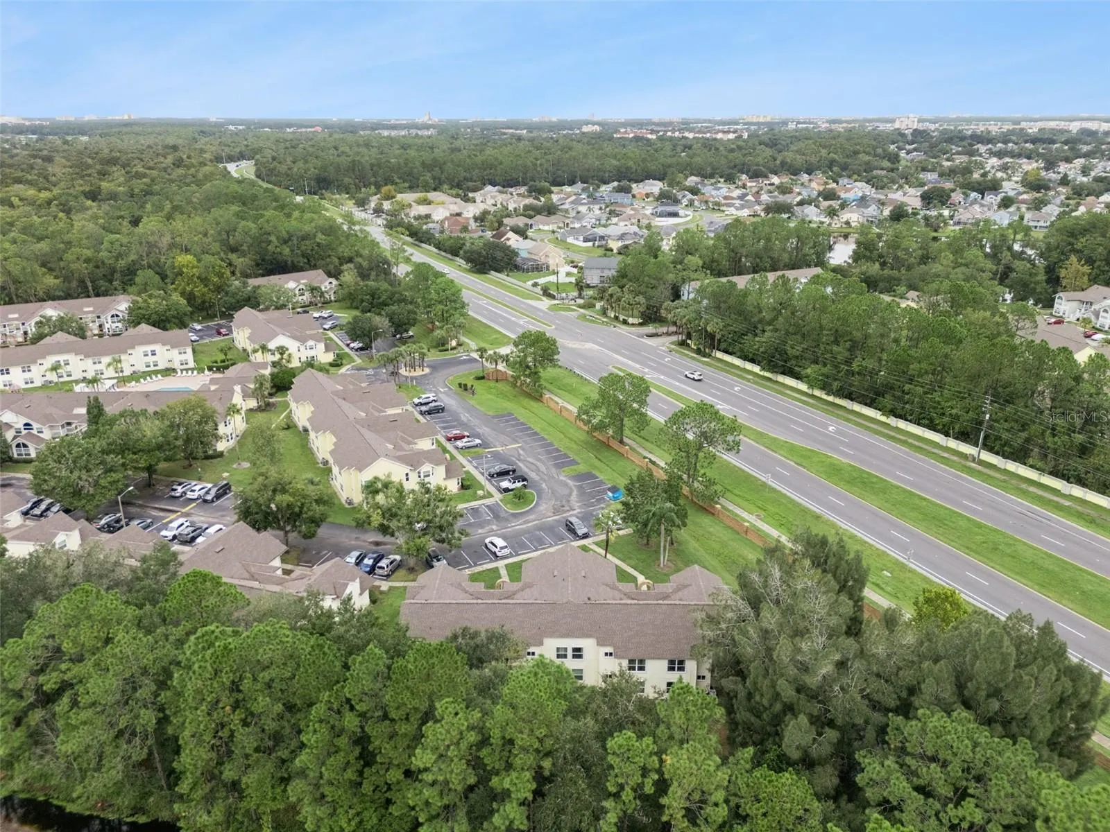 Regional Aerial Perspective: High-altitude aerial view highlighting the property's convenient position along major local roadways surrounded by mature greenery.