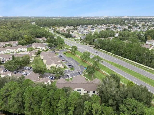 Regional Aerial Perspective: High-altitude aerial view highlighting the property's convenient position along major local roadways surrounded by mature greenery.