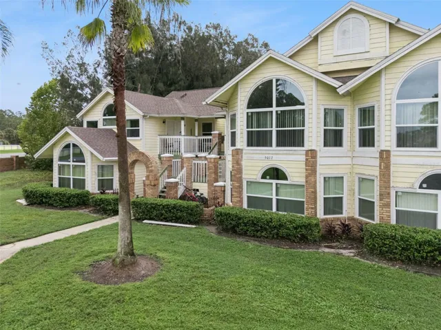 Exterior Elevation: Dynamic exterior angle displaying distinctive window styling, palm trees, and covered staircase entryways.