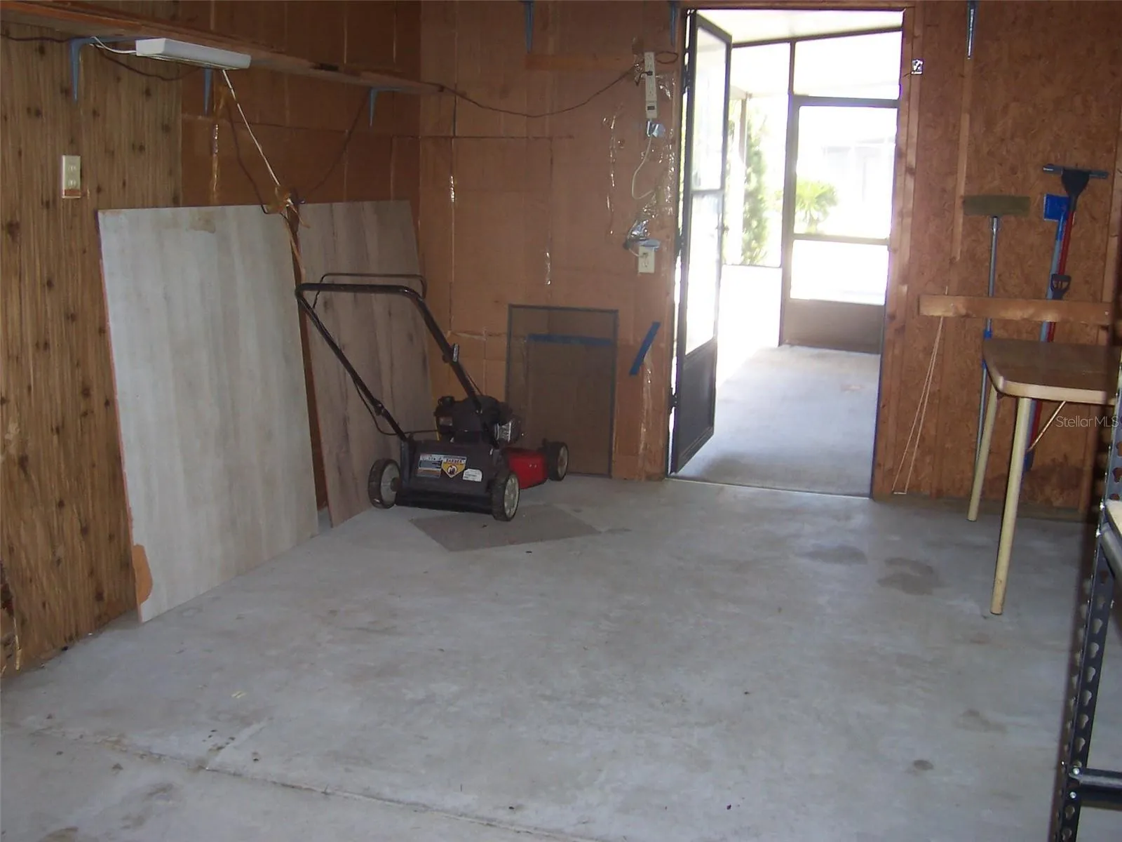 Carport showing landscaping and screen room entrance.