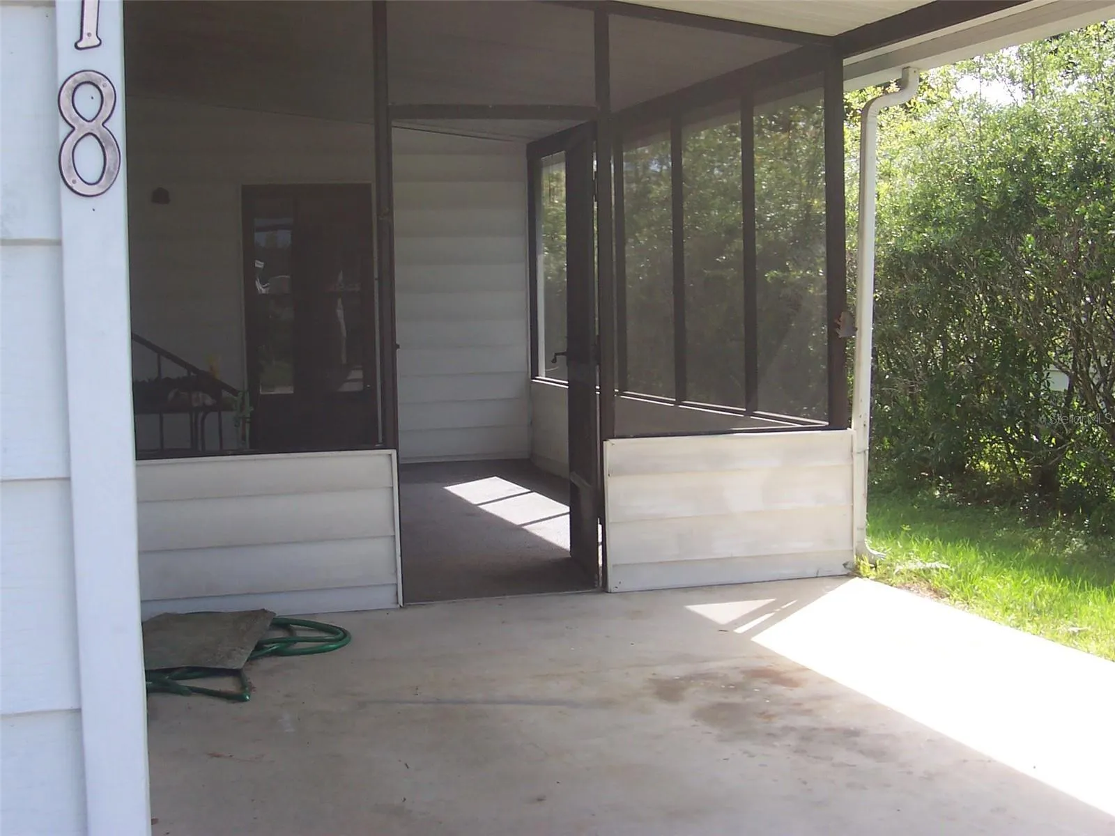 Carport in front of the screen room also shows the immense laundry room/ workshop off the rear of the screen room.