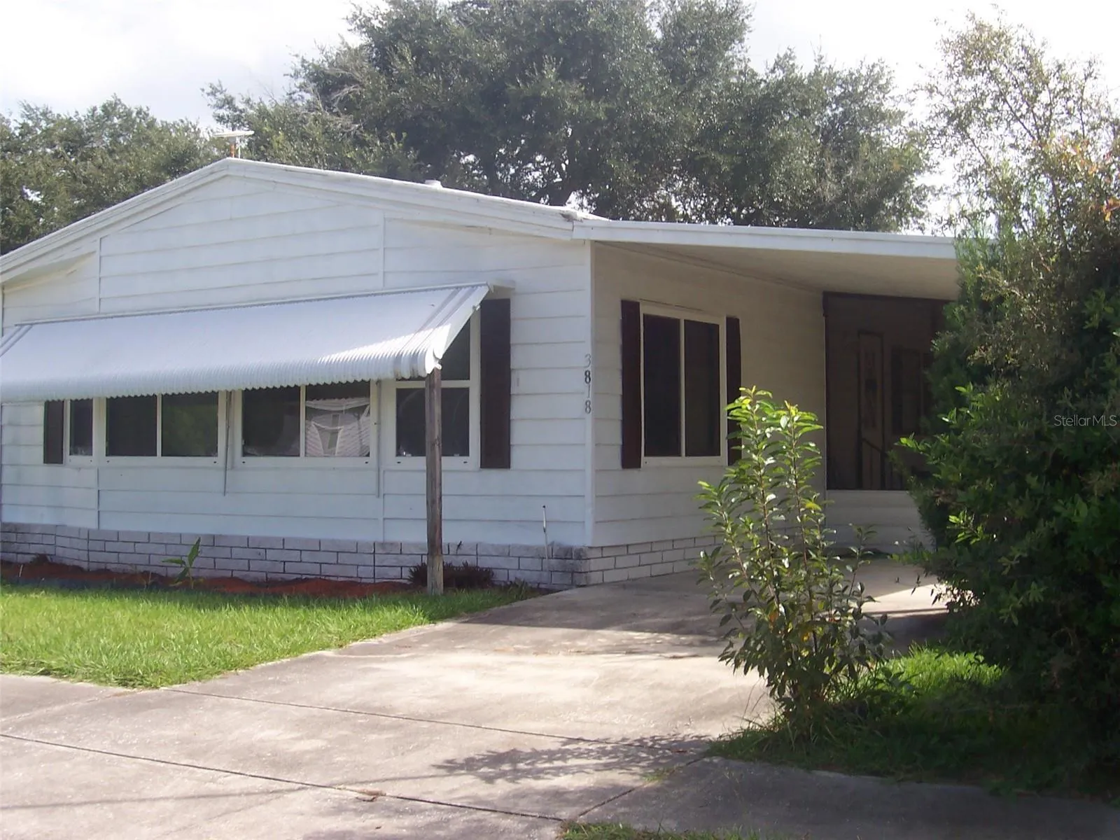Showing front of home at an angle to display the addition windows in the great room.