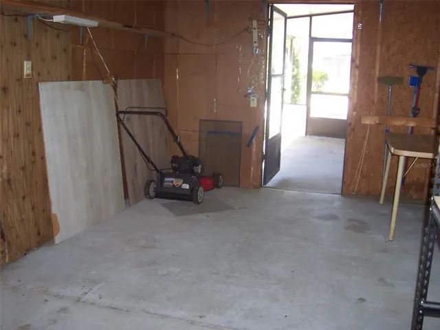 Carport showing landscaping and screen room entrance.