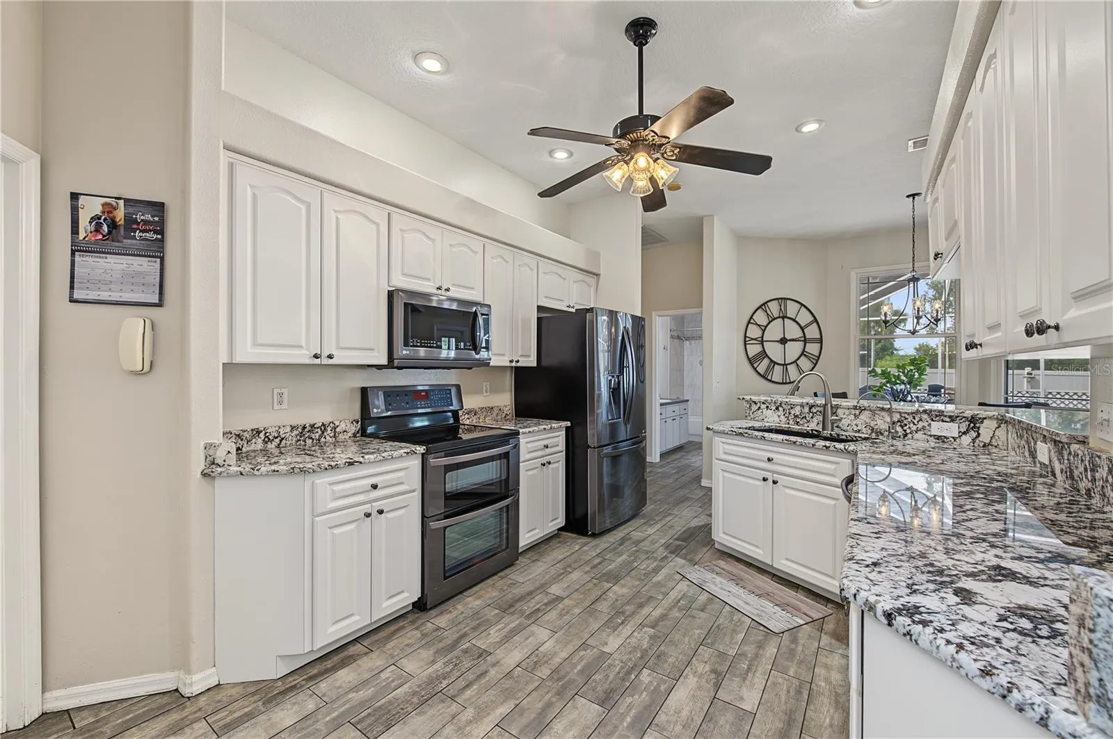 Open Kitchen, Granite Counter Tops, Inset Lights, Updated appliances, Ceiling Fan with lights, Tile Flooring.