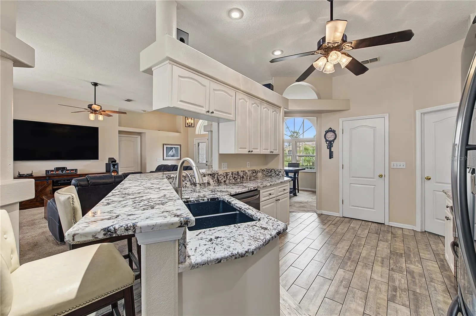 Open Kitchen, Granite Counter Tops, Inset Lights, Updated appliances, Ceiling Fan with lights, Tile Flooring.