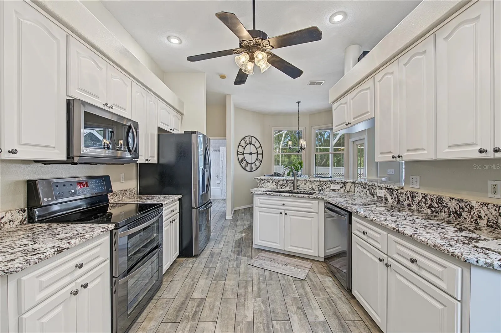 Open Kitchen, Granite Counter Tops, Inset Lights, Updated appliances, Ceiling Fan with lights, Tile Flooring.