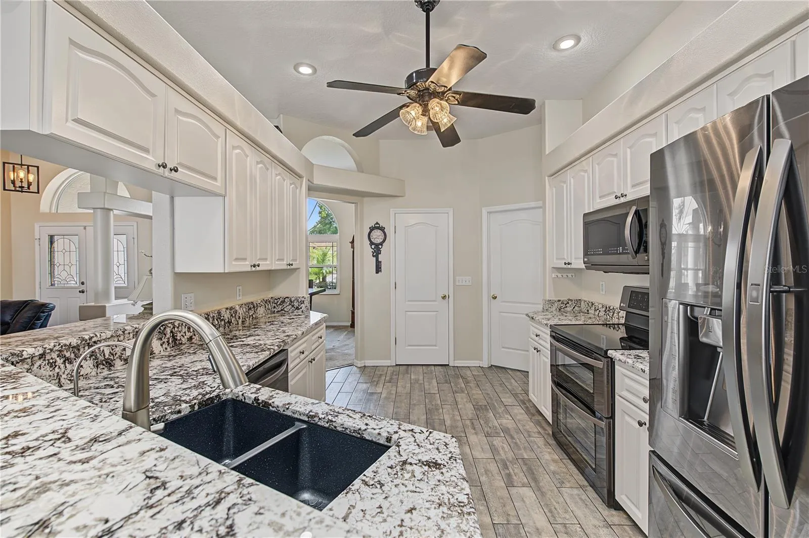 Open Kitchen, Granite Counter Tops, Inset Lights, Updated appliances, Ceiling Fan with lights, Tile Flooring.