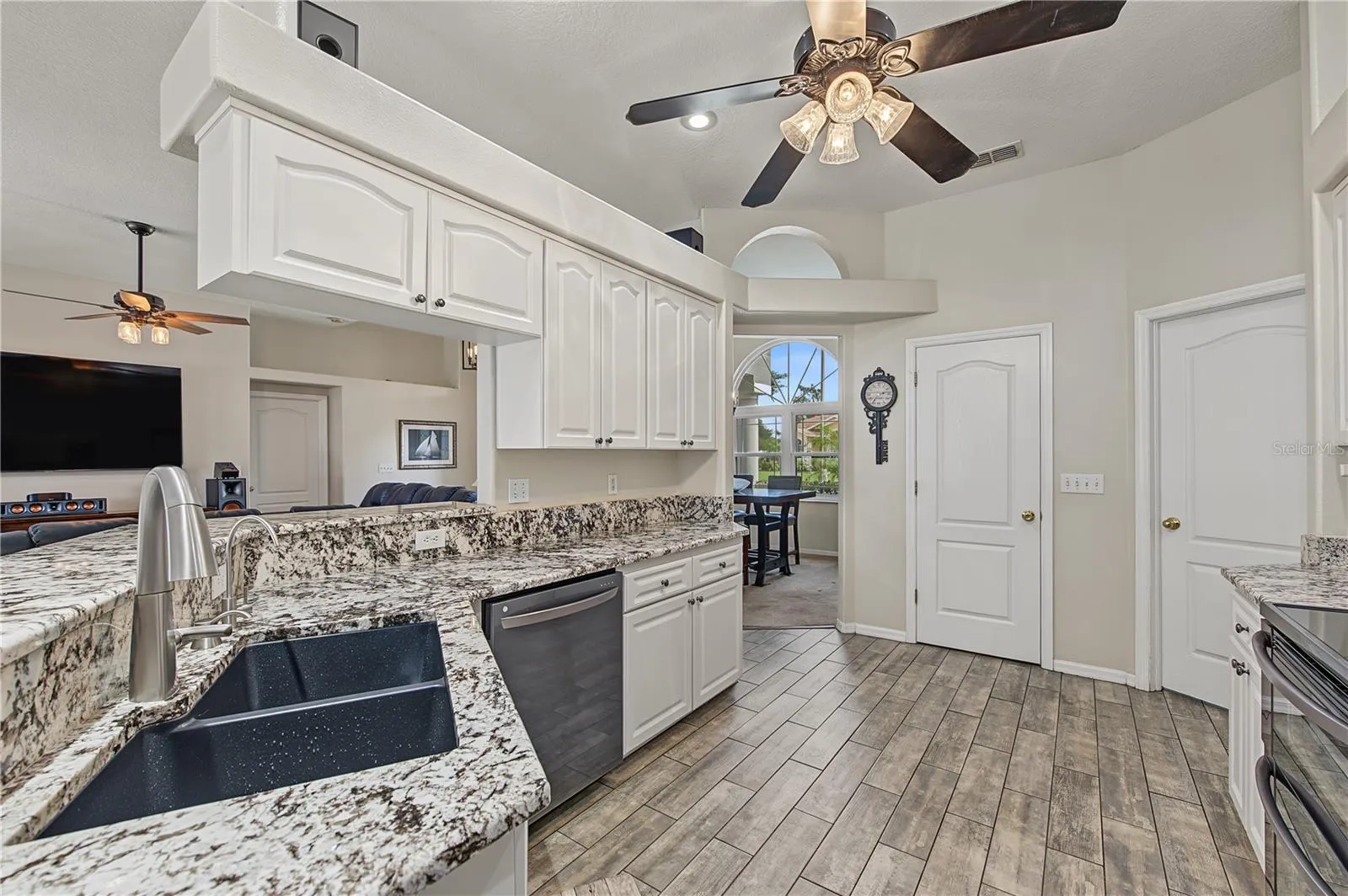 Open Kitchen, Granite Counter Tops, Inset Lights, Updated appliances, Ceiling Fan with lights, Tile Flooring.