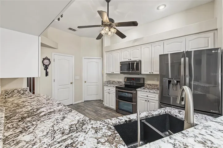 Open Kitchen, Granite Counter Tops, Inset Lights, Updated appliances, Ceiling Fan with lights, Tile Flooring.