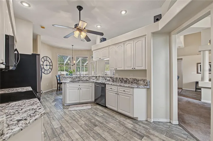 Open Kitchen, Granite Counter Tops, Inset Lights, Updated appliances, Ceiling Fan with lights, Tile Flooring.