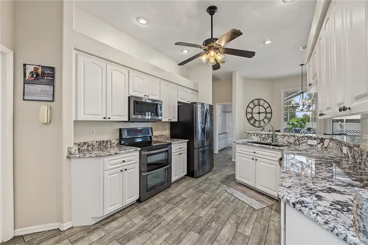 Open Kitchen, Granite Counter Tops, Inset Lights, Updated appliances, Ceiling Fan with lights, Tile Flooring.