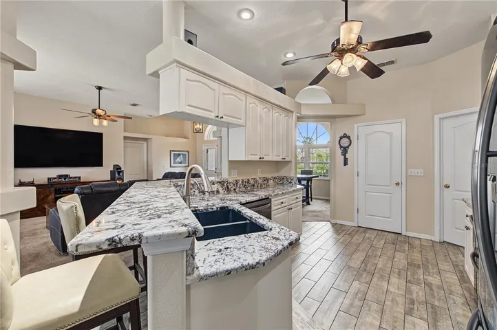 Open Kitchen, Granite Counter Tops, Inset Lights, Updated appliances, Ceiling Fan with lights, Tile Flooring.