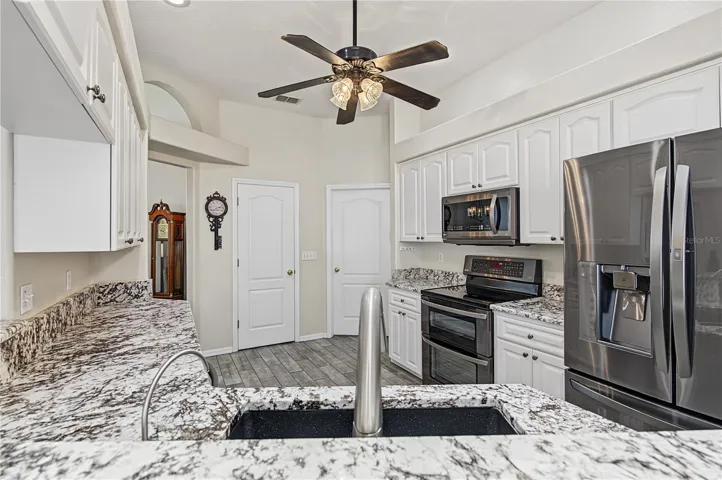 Open Kitchen, Granite Counter Tops, Inset Lights, Updated appliances, Ceiling Fan with lights, Tile Flooring.