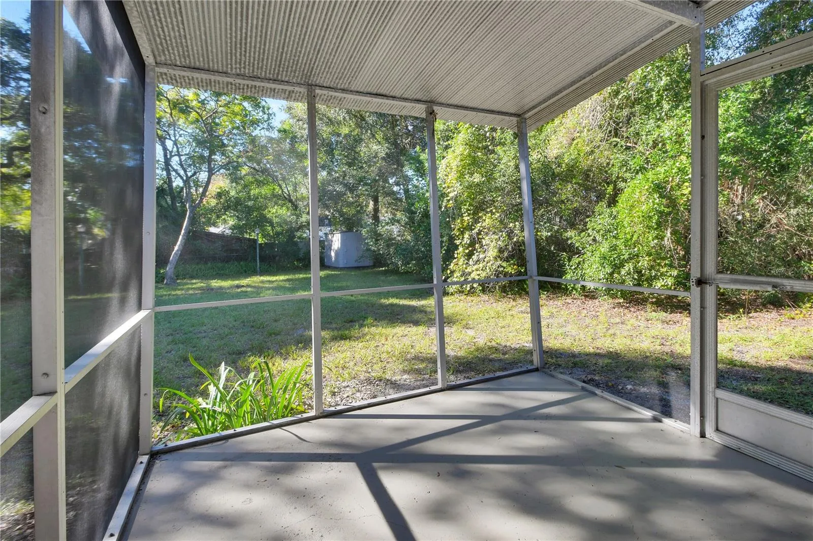 Screened porch with view of the storage shed