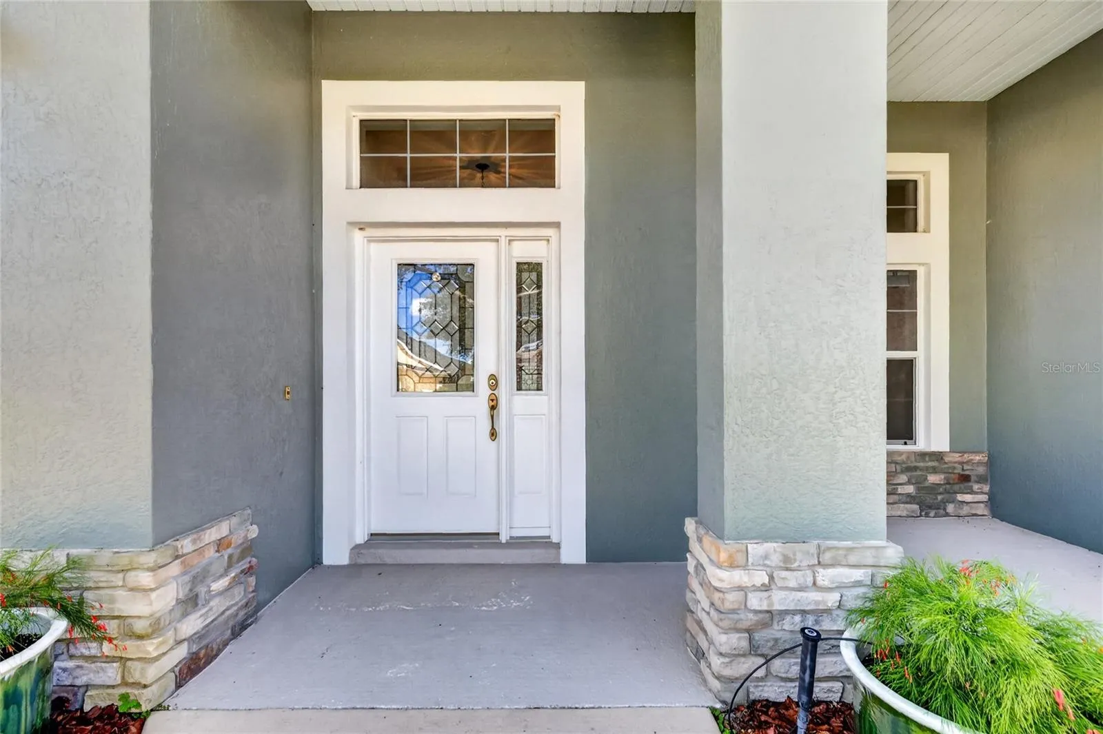The beautiful beveled glass door and window is inviting, offering privacy while allowing natural light to enter the foyer.