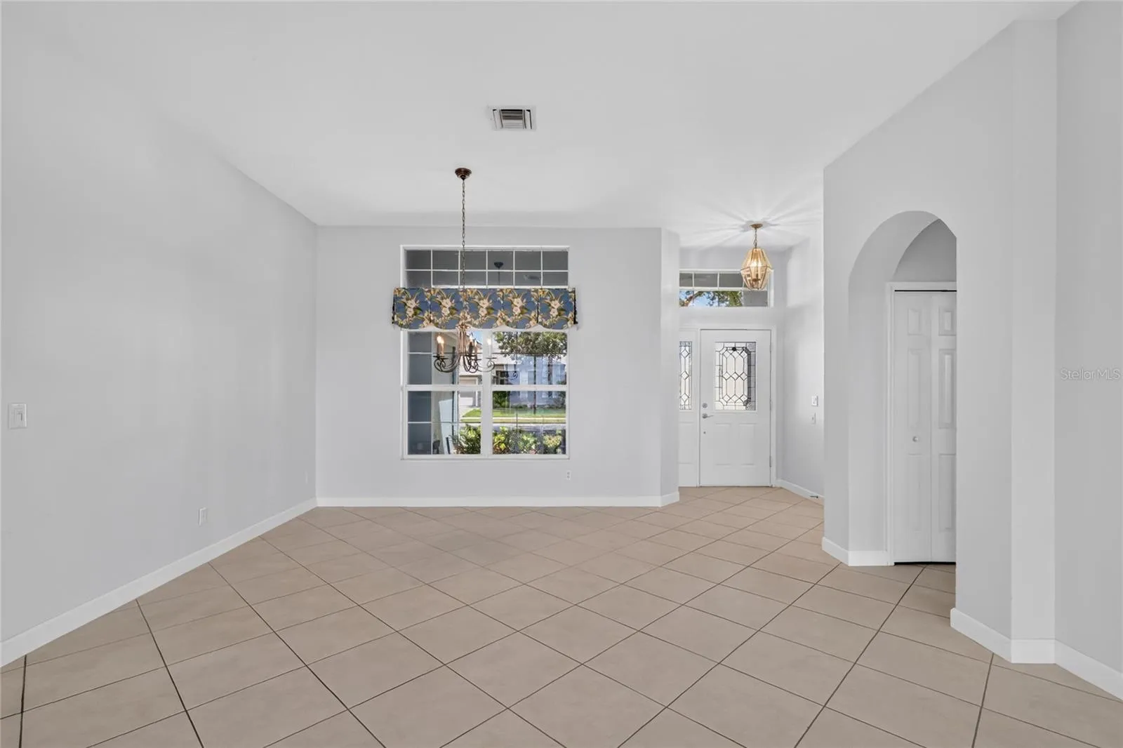 The dining room has a beautiful chandelier and a window to the covered front porch.