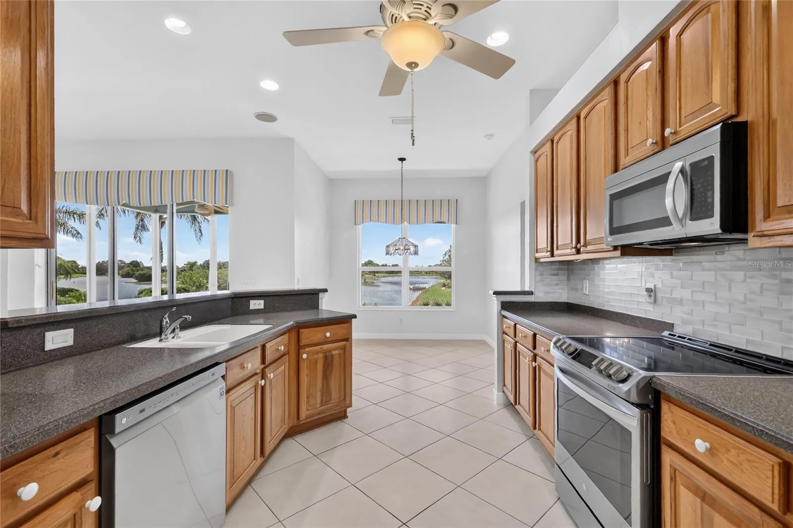 The solid surface countertops, glass tile and stainless steel appliances make this a great kitchen.