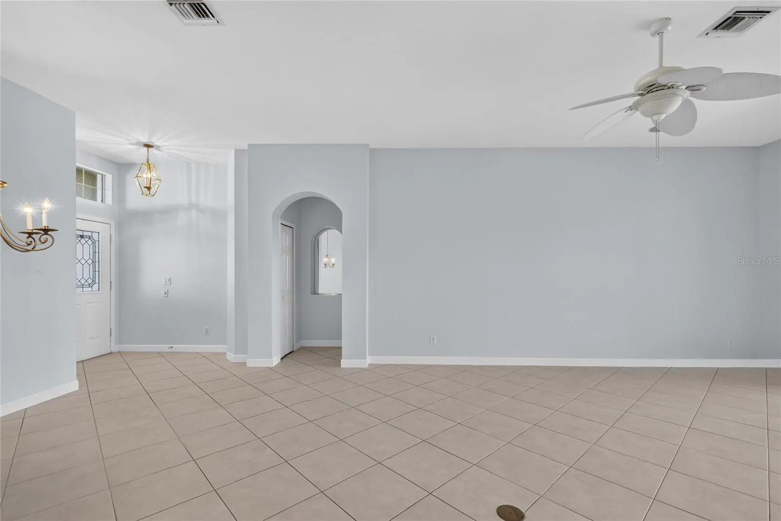 The 18" square ceramic tile is set on the diagonal throughout dining, living and kitchen.  Access to the primary bedroom is off the foyer.