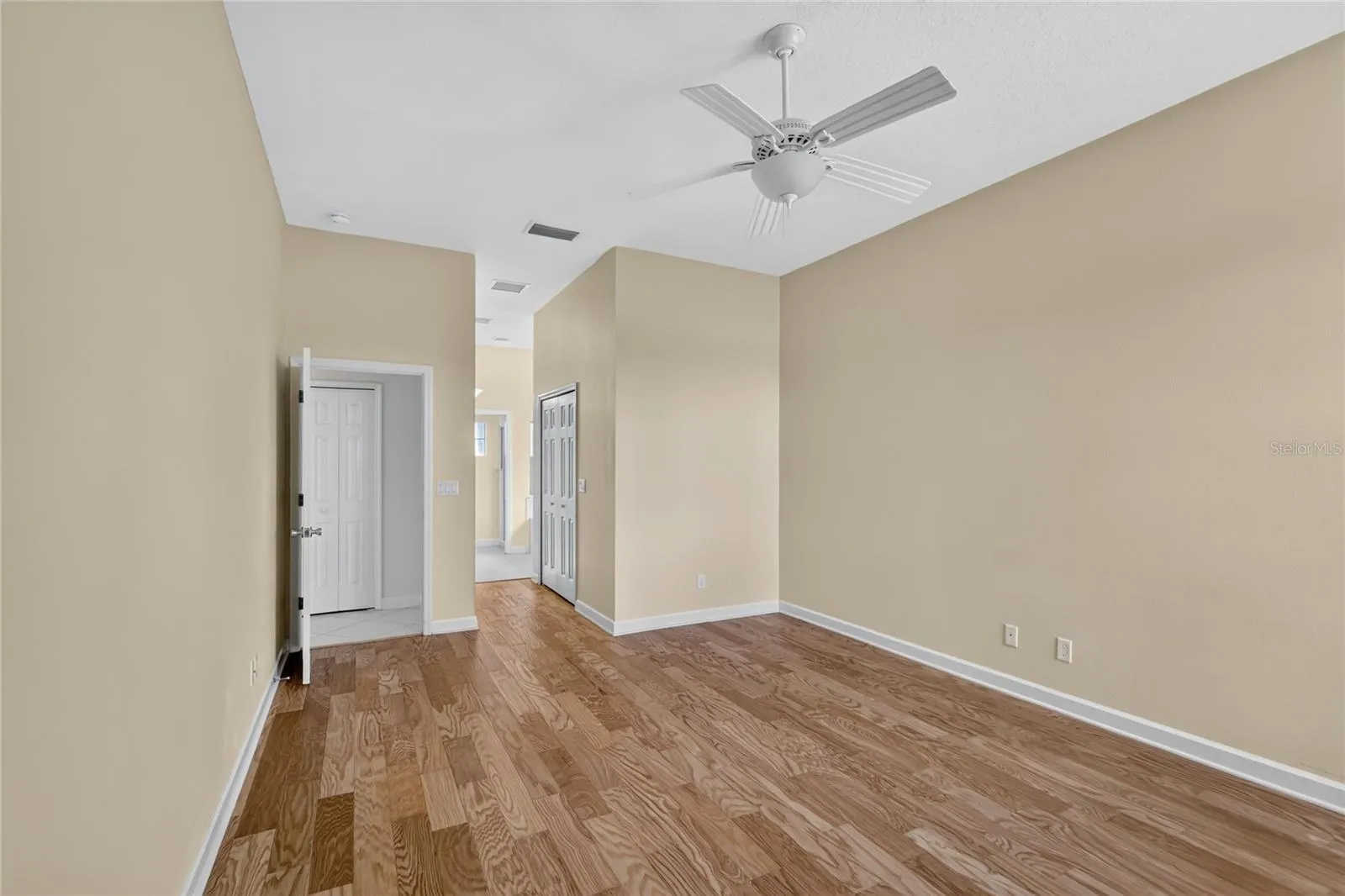 The primary bedroom is spacious and connects to an ensuite bathroom, and has a view to the lake.