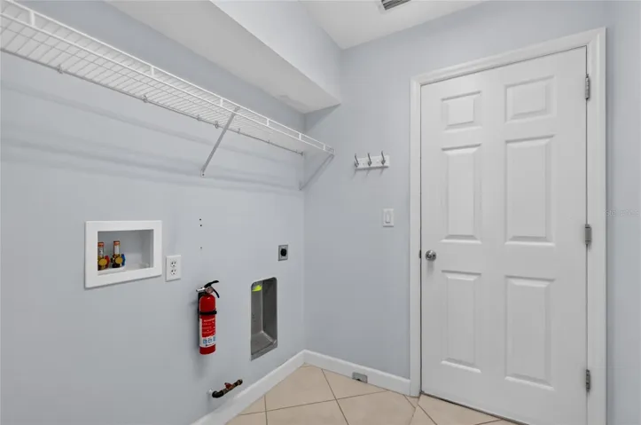 The inside laundry room has some additional storage and provides access to the garage.