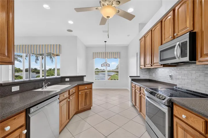 The solid surface countertops, glass tile and stainless steel appliances make this a great kitchen.