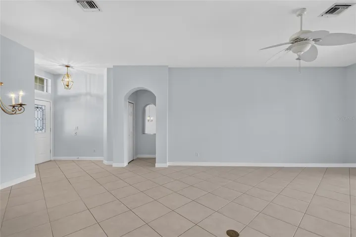 The 18" square ceramic tile is set on the diagonal throughout dining, living and kitchen.  Access to the primary bedroom is off the foyer.