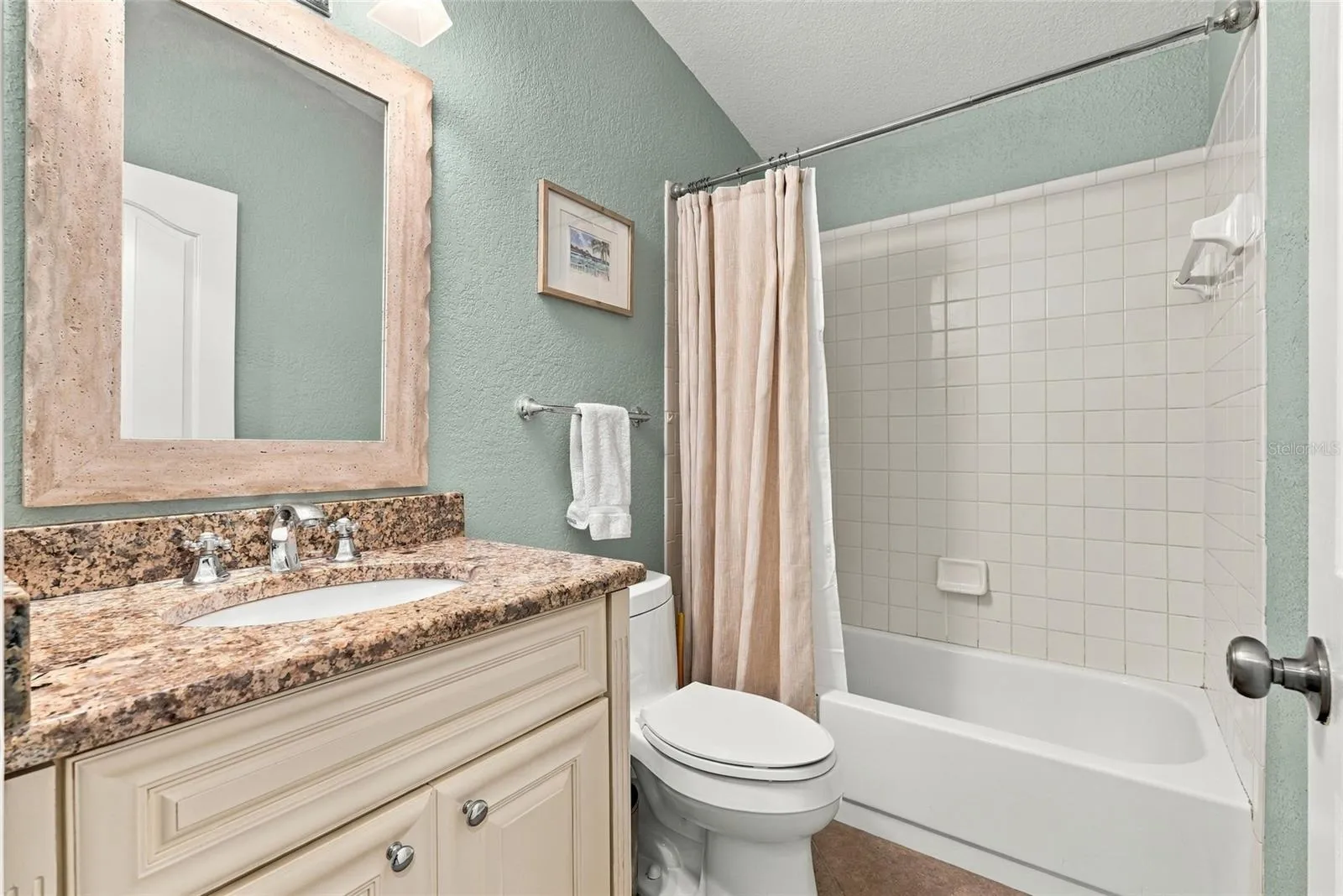 updated upstairs guest full bathroom with shower tub combo.
