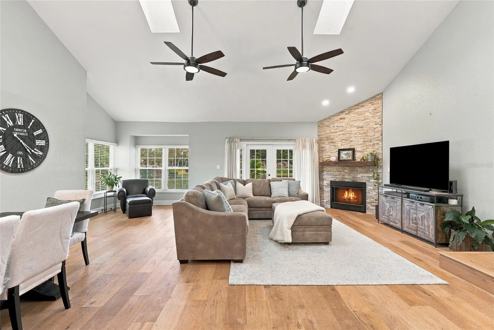 A custom stone fireplace creates a warm focal point within the home’s spacious main living area.
