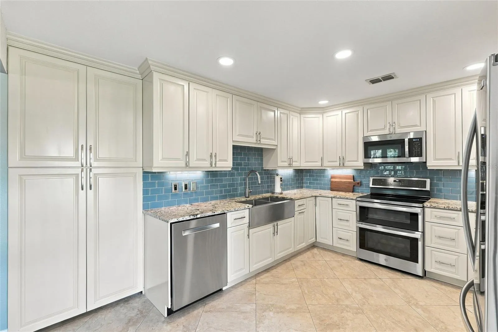 Designed with both style and function in mind, with a custom-built pantry, generous cabinetry, and ample prep space.