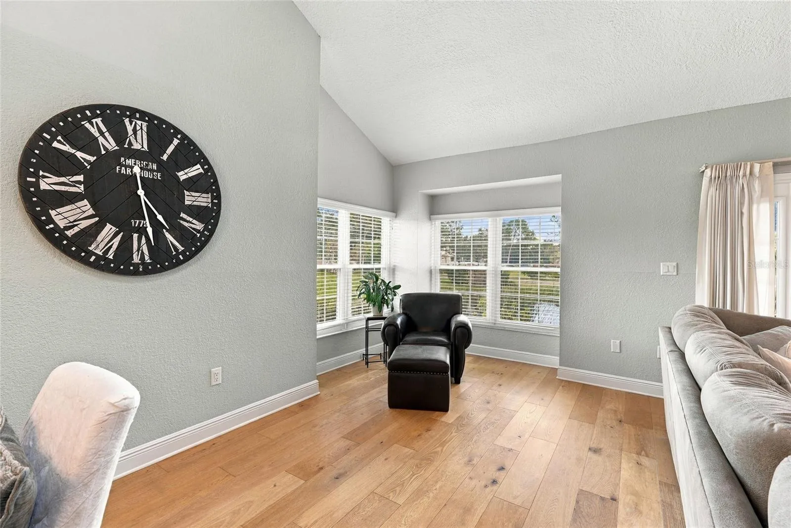 A cozy, light-filled corner creates the perfect spot to read, relax, and take in the tranquil pond views.