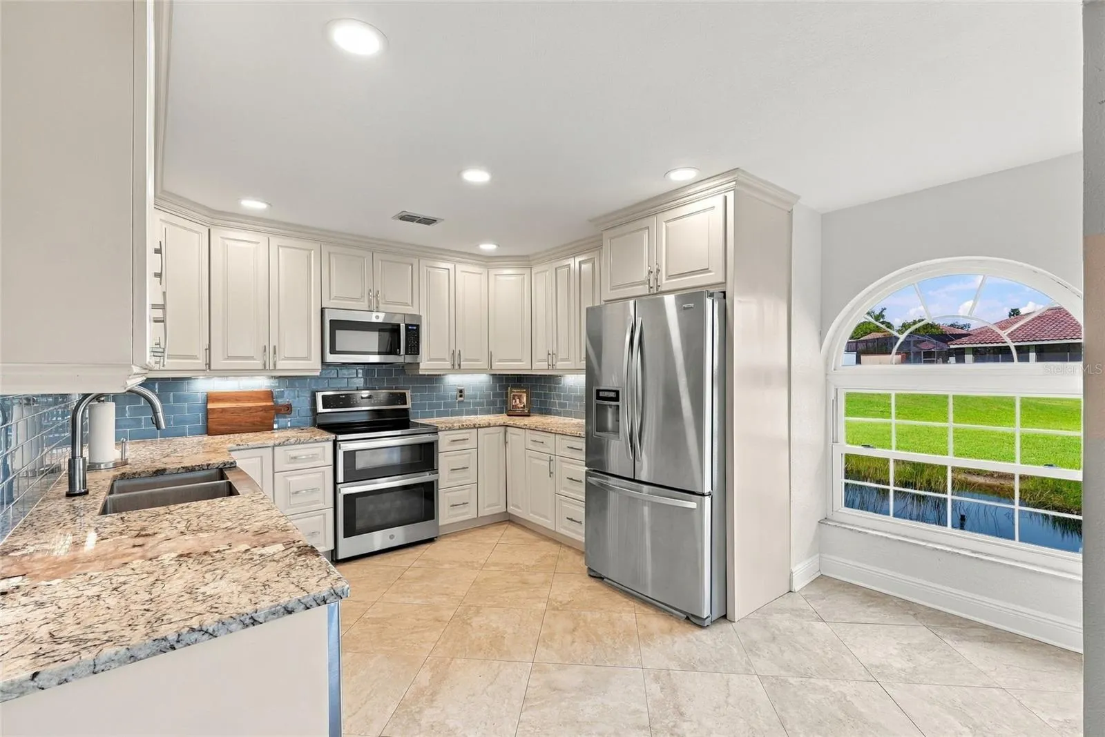 Beautifully updated kitchen featuring striking Norwegian Blue granite countertops and warm Alabama maple cabinetry.