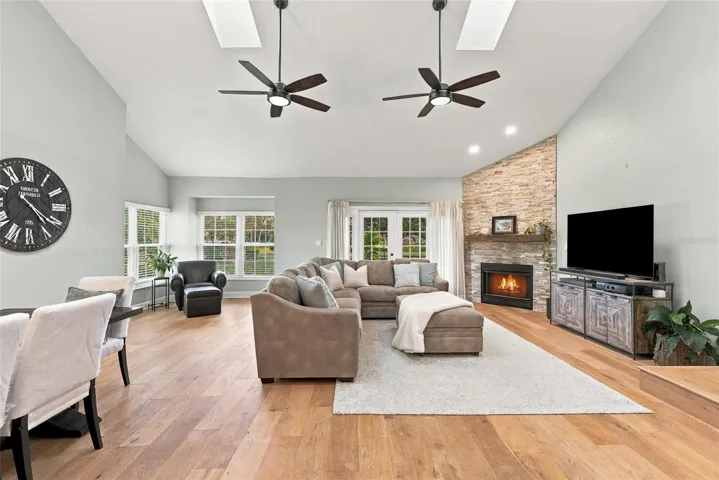 A custom stone fireplace creates a warm focal point within the home’s spacious main living area.