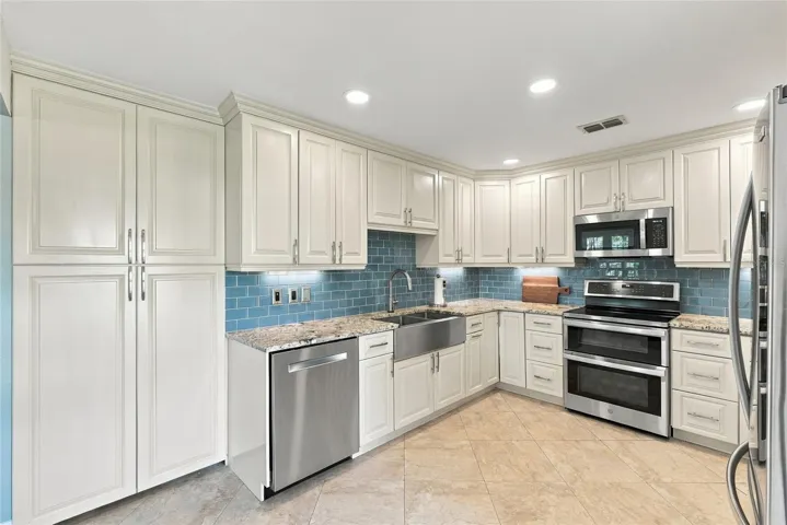 Designed with both style and function in mind, with a custom-built pantry, generous cabinetry, and ample prep space.