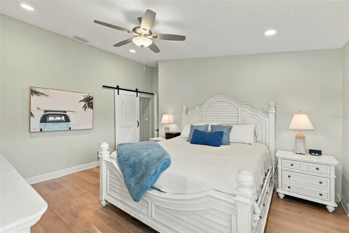 Spacious primary retreat with beautiful hardwood floors, abundant natural light, and a peaceful atmosphere.