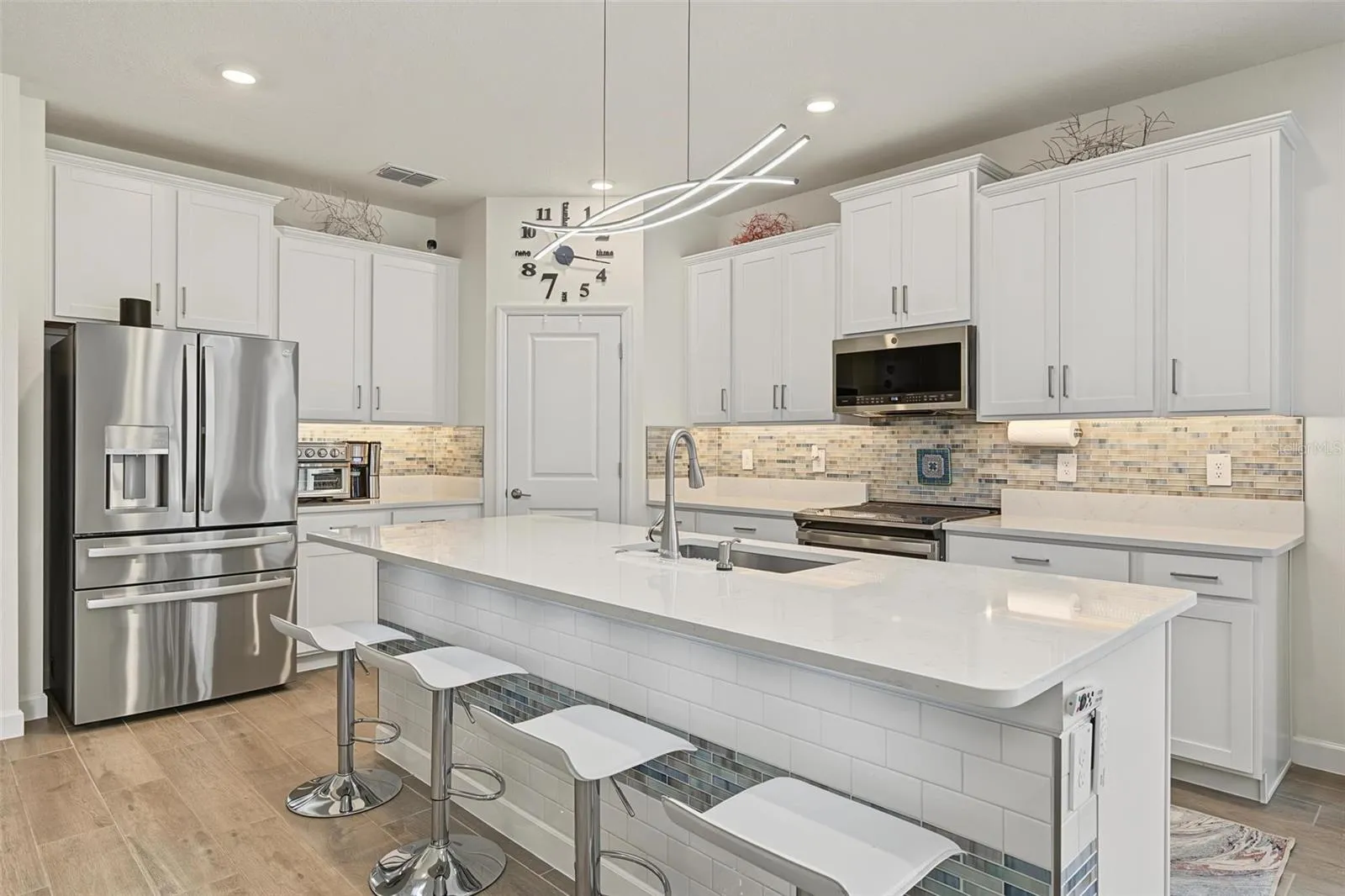 upgraded appliances, backsplash and under cabinet lighting