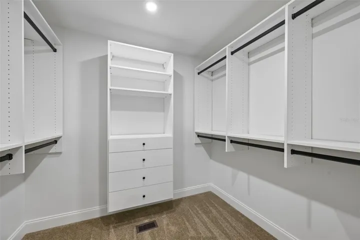 2nd Large walking in closet with California Closet system in the primary suite.