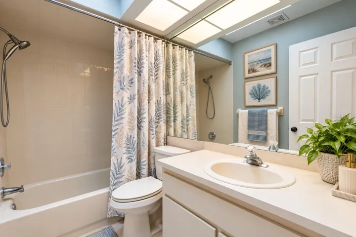 Bathroom shared by second and third bedrooms with virtually staged decor.