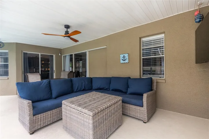 Comfy couch for relaxing on the lanai and the sliders recess open.