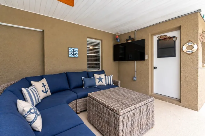 Lanai has outdoor TV and lighting and the door leads to a full bathroom.