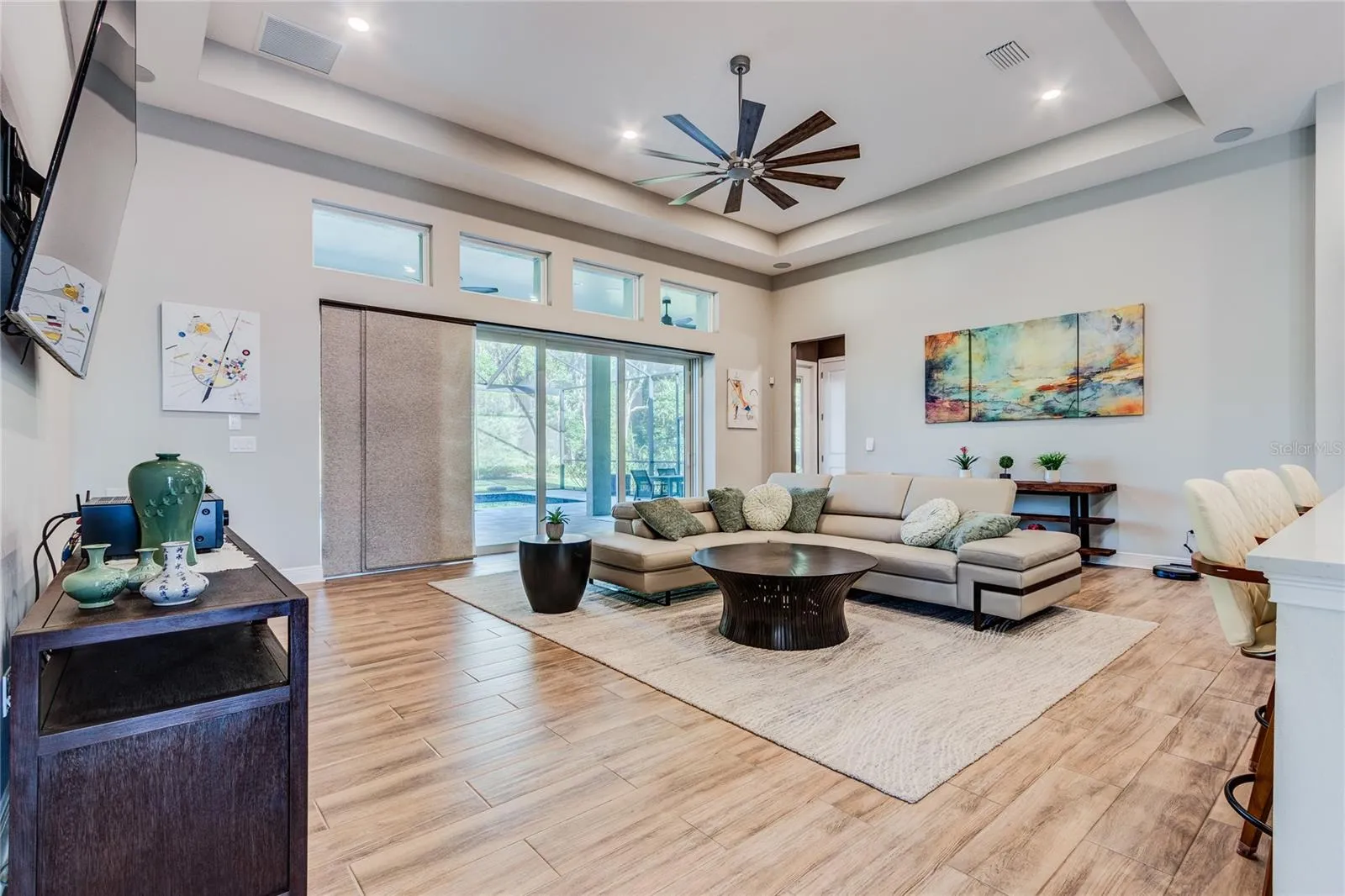 Great Room Tray ceiling with disappearing sliders to pool area