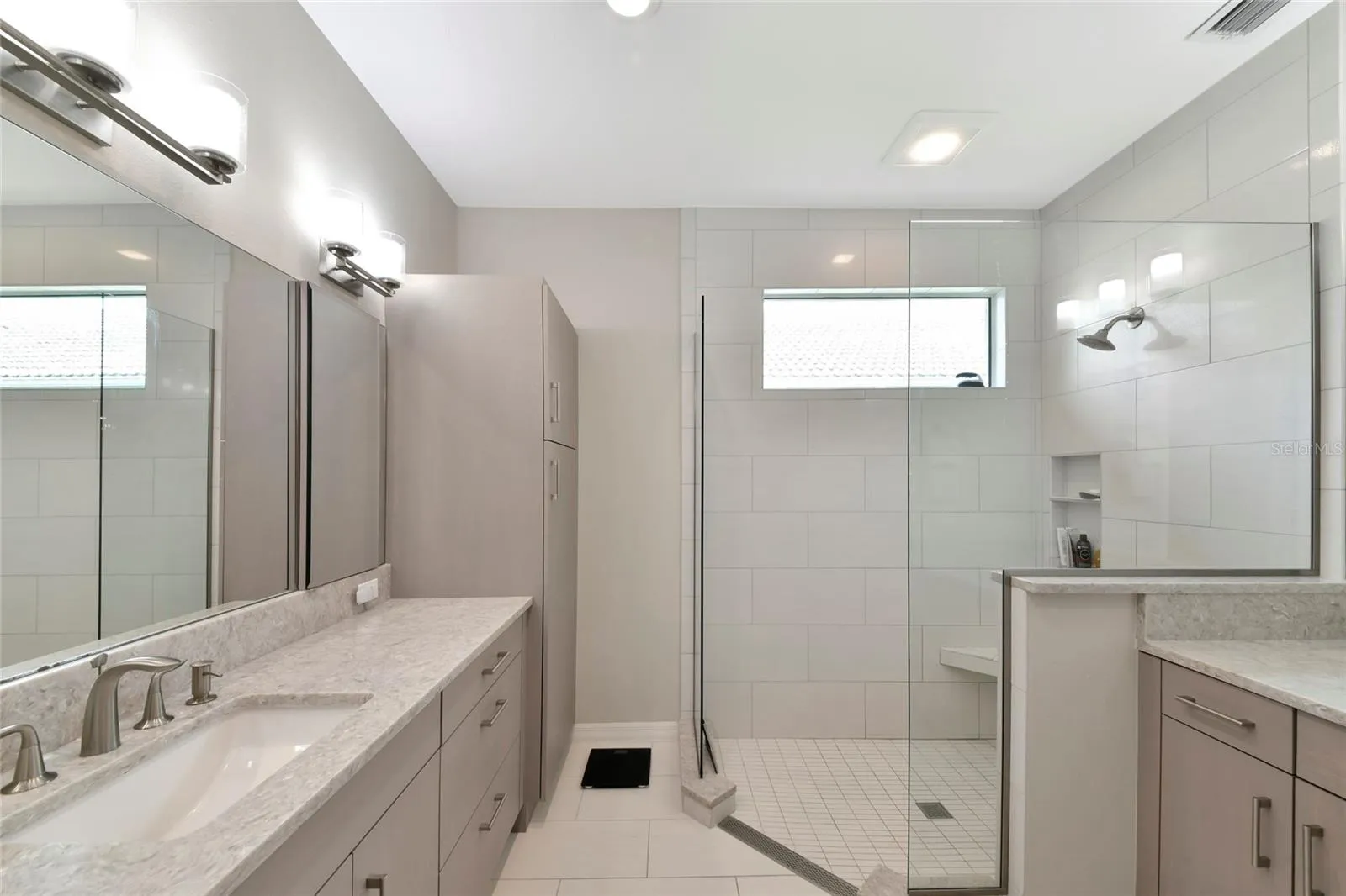New primary bath twin sinks &amp; frameless shower.