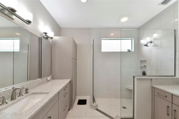 New primary bath twin sinks &amp; frameless shower.