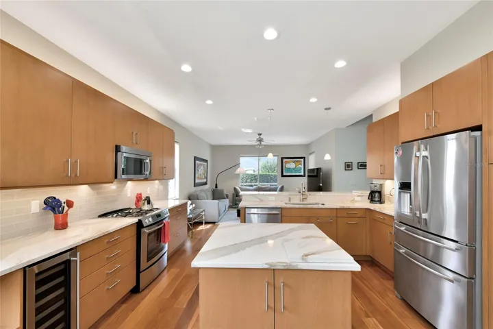 Island kitchen, quartzite counters, wine refrigerator, &amp; Jen-Aire stainless appliances.